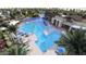 Community pool with surrounding lounge chairs and landscaping at 16673 W Charlotte Dr, Surprise, AZ 85387