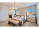 Main bedroom with a neutral color scheme and geometric patterned wall at 16673 W Charlotte Dr, Surprise, AZ 85387