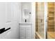 Modern bathroom with white vanity, quartz countertop, and a walk-in shower at 1757 W Sunland Ave, Phoenix, AZ 85041