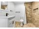 Updated bathroom with white vanity, quartz countertop, and tile shower at 1757 W Sunland Ave, Phoenix, AZ 85041