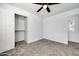 Bedroom with grey carpet, ceiling fan, and walk-in closet at 1757 W Sunland Ave, Phoenix, AZ 85041