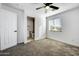 Spacious bedroom with grey carpet, ceiling fan and en-suite bathroom at 1757 W Sunland Ave, Phoenix, AZ 85041