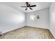 Bright bedroom with wood-look tile flooring and ceiling fan at 1757 W Sunland Ave, Phoenix, AZ 85041