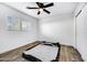 Spacious bedroom featuring wood-look tile floors and ceiling fan at 1757 W Sunland Ave, Phoenix, AZ 85041