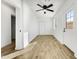 Well-lit bedroom with wood-look tile floors, ceiling fan, and exterior access at 1757 W Sunland Ave, Phoenix, AZ 85041