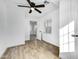 Bright bedroom with wood-look tile floor, ceiling fan, and access to hallway at 1757 W Sunland Ave, Phoenix, AZ 85041
