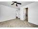 Bedroom with grey carpet, ceiling fan and bathroom access at 1757 W Sunland Ave, Phoenix, AZ 85041