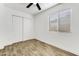 Well-lit bedroom with tile floors, window blinds, and double doors at 1757 W Sunland Ave, Phoenix, AZ 85041