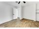 Bright bedroom with wood-look floors and access to hallway at 1757 W Sunland Ave, Phoenix, AZ 85041