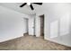 Spacious bedroom featuring neutral carpet, ceiling fan, and access to bathroom at 1757 W Sunland Ave, Phoenix, AZ 85041