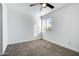 Bright bedroom featuring grey carpet, a ceiling fan and a window at 1757 W Sunland Ave, Phoenix, AZ 85041