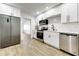 Updated kitchen boasts stainless steel appliances and ample white cabinetry at 1757 W Sunland Ave, Phoenix, AZ 85041