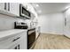 Modern kitchen with white shaker cabinets, stainless steel appliances, and quartz countertops at 1757 W Sunland Ave, Phoenix, AZ 85041