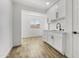 Clean kitchenette with white shaker cabinets, quartz countertops, and a black faucet at 1757 W Sunland Ave, Phoenix, AZ 85041
