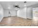 Open living room with tile floors, access to exterior, and ceiling fan at 1757 W Sunland Ave, Phoenix, AZ 85041
