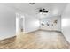 Bright living room with wood-look tile floors and ceiling fan at 1757 W Sunland Ave, Phoenix, AZ 85041
