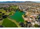 Aerial view of community with lake, golf course, and homes at 17649 W Stinson Dr, Surprise, AZ 85374