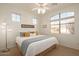 Bright bedroom featuring a king-size bed and large windows at 17649 W Stinson Dr, Surprise, AZ 85374