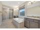 Spa-like bathroom with double sinks, large shower and soaking tub at 18322 W Long Lake Rd, Goodyear, AZ 85338