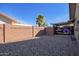 Backyard with gravel, block wall, and covered parking at 21002 N Totem Dr, Sun City West, AZ 85375