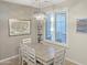 Dining room with a white table and chairs, and a window with shutters at 3575 N Colonial Ct, Florence, AZ 85132