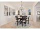 Bright dining room features a round table, chandelier, and plantation shutters at 4040 E Jude Ln, Gilbert, AZ 85298