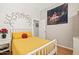 Charming bedroom with a white bed frame and yellow bedding at 4842 E Charleston Ave, Scottsdale, AZ 85254