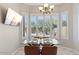 Breakfast nook with glass table and four chairs, overlooking the backyard at 4842 E Charleston Ave, Scottsdale, AZ 85254