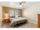 Spacious bedroom with a king-size bed and wood nightstands at 5145 W Fallen Leaf Ln, Glendale, AZ 85310