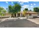 House with stucco exterior, tile roof, and a lush front yard at 5145 W Fallen Leaf Ln, Glendale, AZ 85310