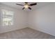 Well-lit bedroom with window and ceiling fan at 6404 W Behrend Dr, Glendale, AZ 85308