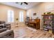 Bright living room with piano, bookcases, and comfortable seating at 6916 E Quince St, Mesa, AZ 85207