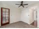 Bedroom with ceiling fan, door to exterior, and double door closet at 7557 N Dreamy Draw Dr # 276, Phoenix, AZ 85020