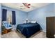 Bright bedroom with a double bed, ceiling fan, and rocking chair at 766 E Compass Ct, San Tan Valley, AZ 85143