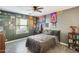 Bedroom with a double bed, large window and eclectic wall decor at 10763 W Deanna Dr, Sun City, AZ 85373