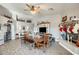 Bright dining area with large wooden table and fireplace at 10763 W Deanna Dr, Sun City, AZ 85373