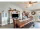 Farmhouse style dining room with rustic table and entertainment center at 10763 W Deanna Dr, Sun City, AZ 85373