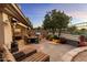 Relaxing stone patio with fire pit, grill, and comfortable seating at 15240 N Clubgate Dr # 147, Scottsdale, AZ 85254