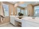 Double vanity bathroom with a large mirror and neutral color palette at 15774 W Superior Ave, Goodyear, AZ 85338