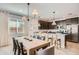 Kitchen with island and adjacent dining area with farmhouse table at 15833 W Kendall St, Goodyear, AZ 85338