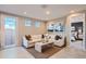 Bright living room featuring a comfortable sectional sofa and large windows at 15833 W Kendall St, Goodyear, AZ 85338