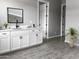 Modern bathroom with white cabinets, gray tile floors, and a sleek sink at 16068 W Questa Dr, Surprise, AZ 85387