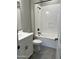 Bathroom with a bathtub, toilet, and vanity with gray tile floors at 16068 W Questa Dr, Surprise, AZ 85387