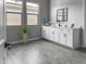 Clean bathroom with white cabinets, gray floor tile, and a modern vanity at 16068 W Questa Dr, Surprise, AZ 85387