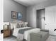 Bright bedroom featuring a comfortable bed, a spacious closet, and stylish decor at 16068 W Questa Dr, Surprise, AZ 85387