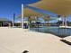 Community pool area with shade structures and lounge chairs at 16068 W Questa Dr, Surprise, AZ 85387