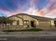 Attractive single-story home with a two-car garage and landscaped front yard at 16068 W Questa Dr, Surprise, AZ 85387