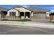 Well-maintained single-story house with a two-car garage and neat landscaping at 16068 W Questa Dr, Surprise, AZ 85387