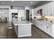 Modern kitchen with white cabinets, a large island, and stainless steel appliances at 16068 W Questa Dr, Surprise, AZ 85387