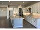 Modern kitchen with white cabinets, quartz countertops, and stainless steel appliances at 16068 W Questa Dr, Surprise, AZ 85387